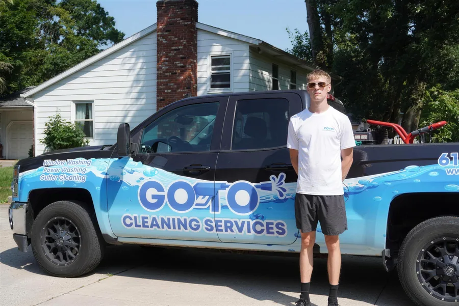 Go To Cleaning Services technician standing beside the company's wrapped work truck